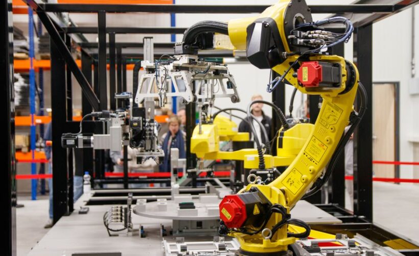 Close-up of a yellow industrial robotic arm in action at a modern manufacturing facility. - Photo by Freek Wolsink on Pexels