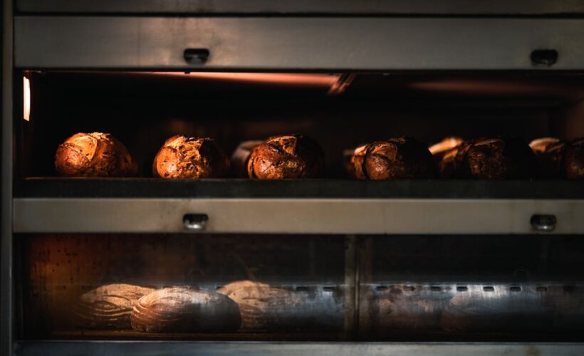 Warm artisan bread being baked to perfection in a professional industrial oven. - Photo by Chris F on Pexels