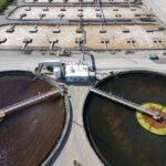 Aerial shot of an industrial water treatment plant with large circular tanks. - Photo by Giant Asparagus on Pexels