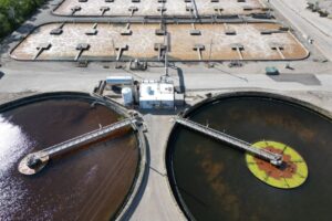 Aerial shot of an industrial water treatment plant with large circular tanks. - Photo by Giant Asparagus on Pexels