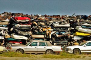 A large stack of disposed vehicles in an outdoor junkyard. - Photo by Benhur Emmanuel on Pexels