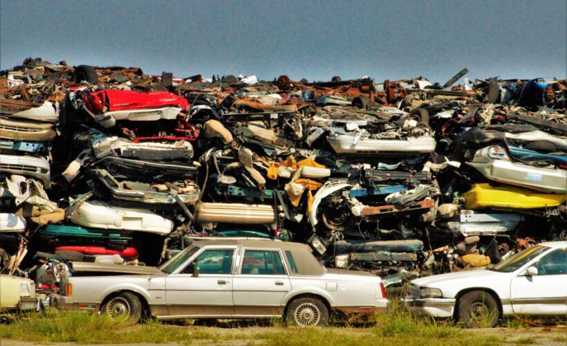 A large stack of disposed vehicles in an outdoor junkyard. - Photo by Benhur Emmanuel on Pexels