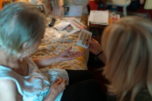 An elderly woman receives medication assistance at home, emphasizing home healthcare and caregiver support. - Photo by Jsme MILA on Pexels