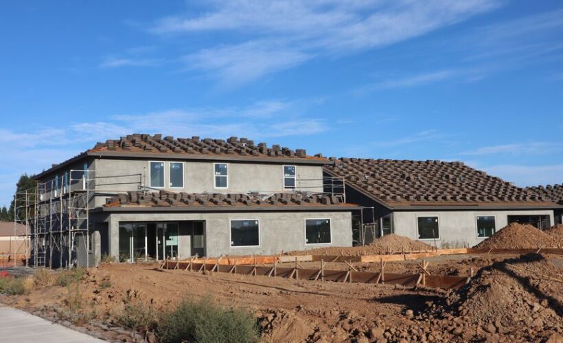 A modern suburban house under construction against a clear blue sky. - Photo by D Goug on Pexels
