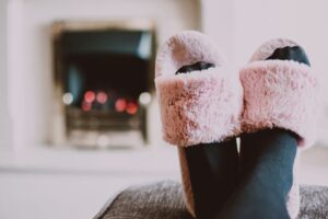 Relaxing by the fireplace with fuzzy slippers and warm socks indoors. - Photo by Lisa Fotios on Pexels